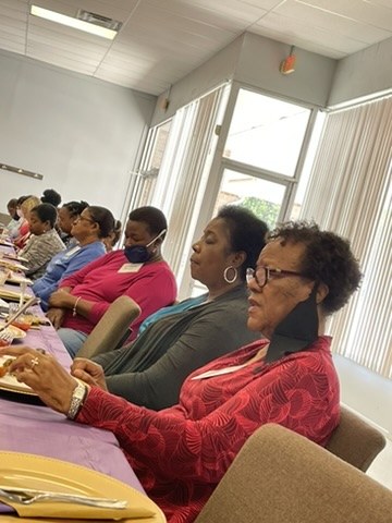 Women seated together during a conference gathering